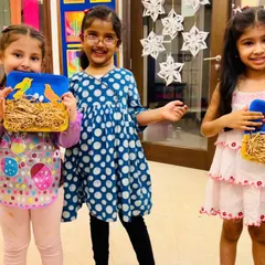 Art plus laughter equals childhood magic! These three young artists are so proud of their mixed-media bird's nest creations, a project that combines painting and craft.