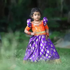 Here is the elder sister showing off her outfit with a confident pose. The rich colors and classic silhouette make this a perfect choice for any festive occasion or family celebration.