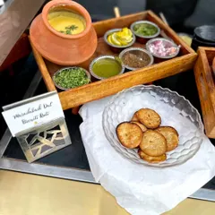 A taste of tradition. Slow-cooked Muradabadi Dal served with all the classic condiments and crispy, flaky Biscuiti Roti for a wholesome and authentic experience.