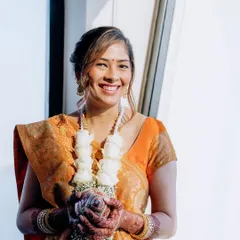 A bright, happy shot from the Mandvo ceremony. The natural light highlights her glowing skin and the simple, elegant makeup.