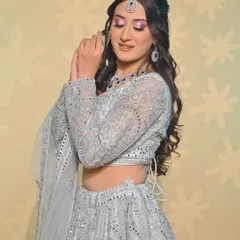 A dreamy look in a silver-grey lehenga with a pop of pink on the eyes. This is a great example of our students' ability to create modern and fresh looks.