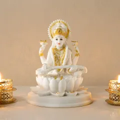 This elegant white resin sculpture of Goddess Saraswati, detailed with gold accents, embodies wisdom and artistry. It's a graceful addition to a study, library, or any space where you seek inspiration.