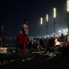 Under the cover of night at Manikarnika Ghat in Varanasi, funeral pyres burn brightly against the dark waters of the Ganges. My approach to documenting these sacred rites is quiet and respectful, focusing on the atmospheric reality of the scene.