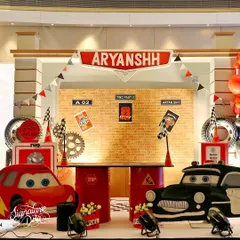This 'Two Fast' Cars-themed party was all about the details. I created a custom pit stop for the birthday boy, complete with character cutouts of Lightning McQueen, themed props, and a backdrop that puts you right in the middle of the race.