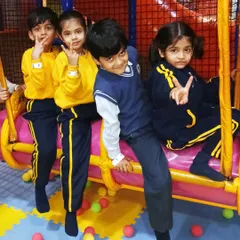 A group of students in their school uniforms having a great time on the swinging log ride. It's a fun activity that encourages cooperation.