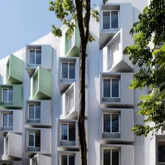 The facade of a research center for Artificial Intelligence, featuring dynamic, three-dimensional window modules. These structures are not just aesthetic but also function as shading devices, optimizing natural light for the interior research spaces.