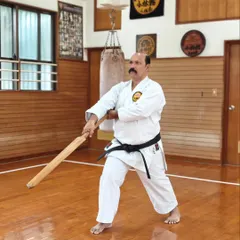 Practicing with the Eku in the historic Honbu Dojo in Okinawa. This training connects us directly to the source of our art, ensuring the techniques I pass on are pure and effective.