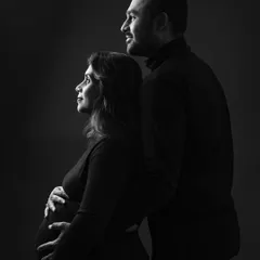 A classic couple portrait looking towards the future together. The use of shadow and light in this black and white shot creates a feeling of strength and unity.