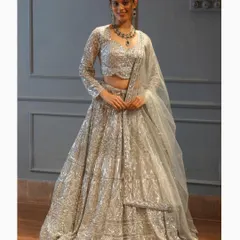 What you see is what you get with our outfits. This full shot shows the incredible sparkle and craftsmanship of our silver sequin lehenga, a perfect choice for a modern bride or guest.