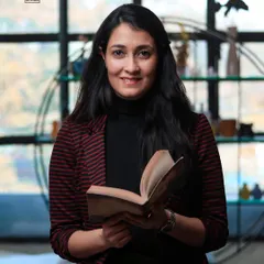A variation of the headshot, incorporating a book as a prop to reflect the subject's personality or profession.