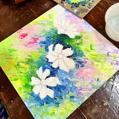 The first step is often the most colorful. Here's a canvas with the background colors blocked in, ready for the main floral elements to be layered on top with a palette knife.
