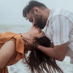 An intimate and passionate kiss, with the ocean as the only witness. This close-up captures the raw emotion of a beach pre-wedding shoot.