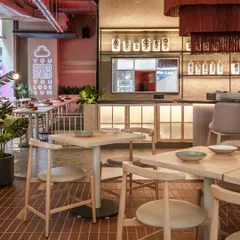 The "You Dim Sum You Lose Sum" neon sign adds a playful, quirky touch that embodies the brand's voice. It acts as a fun photo opportunity for guests and reinforces the restaurant's casual, energetic atmosphere.