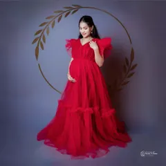 A studio shot of our bold red ruffled gown. This dress is a statement piece, perfect for clients who want to stand out in their maternity or pre-wedding photos.