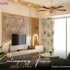 The living room of our 'Contemporary Fusion' 2BHK project in Pune. We used a mix of textures, including a marble-finish TV panel and wooden fluting, to create a space that is modern yet full of character.