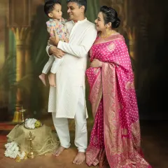 There's nothing more beautiful than capturing the whole family's excitement. This studio portrait, with everyone in coordinated traditional wear, shows the love and anticipation as you wait for your new arrival.