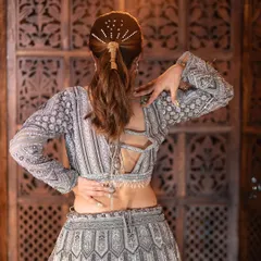 A closer look at the craftsmanship on this grey embroidered lehenga. The detailed back and sleeve work show how we can create a truly glamorous and high-end look for your event.