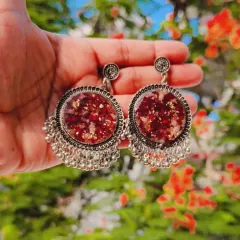 Matching jhumka earrings made with preserved flowers in resin. These traditional-style earrings are a beautiful way to wear your memories.