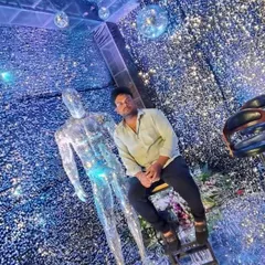 A guest poses within the shimmer wall room. The dynamic, sparkling background ensures that every photo taken at the event looks spectacular.