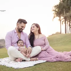 A beautiful family of three enjoying a peaceful moment together outdoors. We focus on capturing the love and connection that you can feel just by looking at the photo.