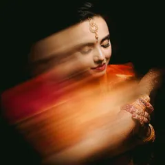The color version of my motion blur portrait technique. The warm tones of the bride's saree streak across the frame, creating a vibrant and dynamic piece of art that captures her energy.