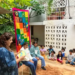 A teacher reads a story during our graduation ceremony. These celebrations are filled with songs, poems, and shared memories, honoring the journey of the children moving on to new adventures.