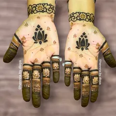 For a touch of modern elegance, I designed this minimal mehendi featuring a bold lotus motif on the palm and matching lotuses on each fingertip. It's a simple yet striking look, ideal for guests who prefer understated henna art.