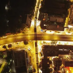 An aerial long exposure shot creating a 'warp speed' effect with traffic lights on a Mumbai flyover.