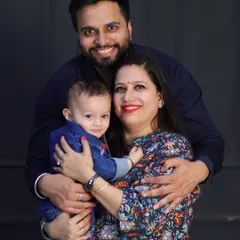 A warm family hug. Posing against a dark, simple background makes the subjects stand out and emphasizes their emotional connection.