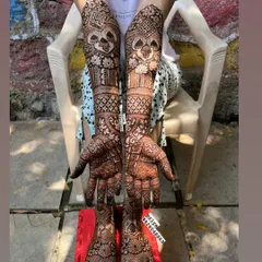 Here is a complete bridal mehndi look, with detailed, symmetrical designs covering the arms, hands, feet, and legs. I ensure the patterns flow beautifully for a stunning result from every angle, making you feel like a queen on your special day.