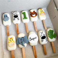 A closer look at the jungle themed cakesicles we made for Sayuri's first birthday. The set includes adorable, hand-decorated animal faces like a hippo, zebra, tiger, and elephant, plus a personalized one with her name.