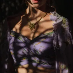 The play of light and shadow across the bride's lavender outfit creates a stunning, artistic portrait. We love using natural light to paint our frames, highlighting the details and mood of the moment.
