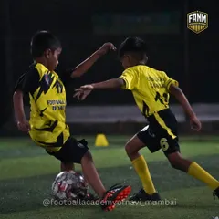 A player shields the ball from a defender in a competitive 1-on-1 situation. I teach players how to use their body to protect the ball and maintain possession.