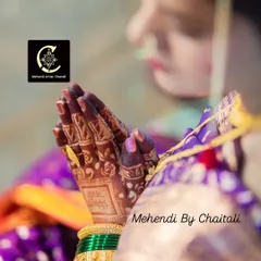 The result of using high quality, fresh mehendi paste. This candid shot from a wedding captures the rich, dark maroon stain on the bride's hands during a ritual.