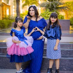 A maternity session is a family affair. Here, the mother-to-be celebrates with her two daughters, creating a beautiful memory before the new baby arrives.