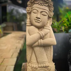 A close-up of our sandstone garden doll. The artisan has captured a serene expression and detailed the floral crown and traditional clothing, making it a beautiful piece of art.