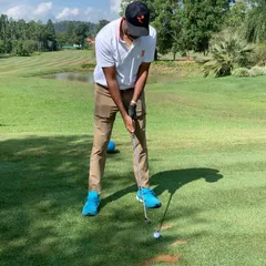 Tennis champion Rohan Bopanna preparing to hit a shot on the fairway. It's fascinating to see how the coordination and power from one sport can translate to another.