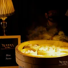 Our live dim sum station, where guests can enjoy freshly steamed dumplings. The moody lighting and elegant setup create an inviting corner for guests to gather and enjoy authentic Asian flavors.