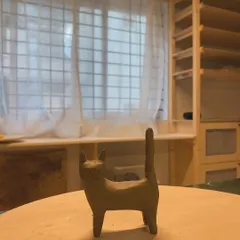 A small, hand-sculpted cat figure, standing proudly in my studio. This piece, which I call "Luna," is a reminder to find comfort and peace in your own company.