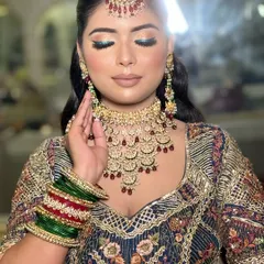 A close-up of the blue eyeshadow look, showing the beautiful contrast with the traditional red and green bangles.