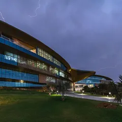 The Jaquar Global Headquarters captured against a dramatic sky. This project showcases our ability to create dynamic, large-scale commercial architecture that is both a landmark structure and an energy-efficient, net-zero building.