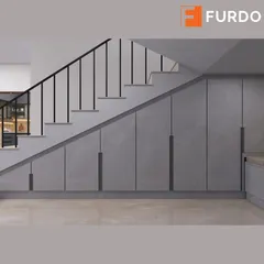We transformed the often-unused space under the stairs into a massive storage unit with sleek, handleless doors, seamlessly blending it with the home's modern aesthetic.