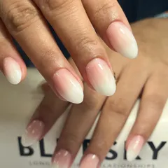 A full view of these elegant baby boomer nails on an almond shape. The gradual fade is smooth and flawless, creating a sophisticated and clean aesthetic.