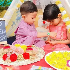 A tender moment as a sister ties a rakhi on her brother's wrist. We create a beautiful, traditional setting for children to celebrate this special festival.