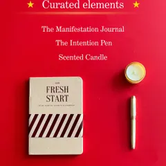 The curated elements of the Reset Kit: The Manifestation Journal, The Intention Pen, and a scented candle. Everything you need to clear your mind and set new goals.