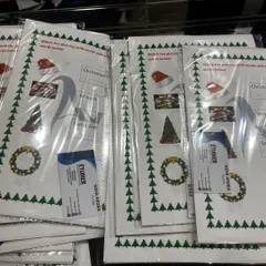 Preparing activity kits for a Christmas carnival. Each kit includes fun, educational worksheets and crafts to get the kids into the holiday spirit.