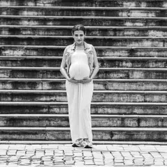 Using the strong lines of city architecture, like these steps, creates a powerful backdrop for a simple and elegant black and white maternity portrait.