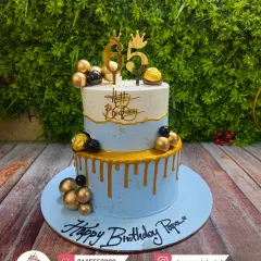 A beautiful two-tier cake for Papa's 65th birthday. The combination of light blue, white, and gold drip gives it a royal and distinguished look.