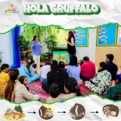 A group of parents and children listen intently during our "Hola Gruffalo" event. I use expressive storytelling to captivate the children's attention and draw them into the world of the book.