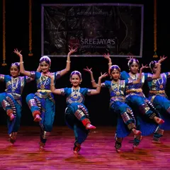 The power and precision of the Kalakshetra style, demonstrated beautifully by this group of dancers. Their coordinated leaps show excellent form and training.
